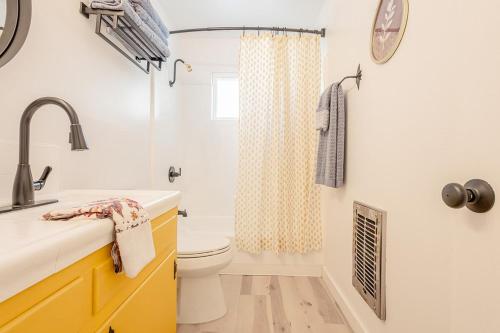 a bathroom with a sink and a toilet and a shower at Sunshine Loft in Wrightwood