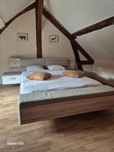 a bedroom with a bed with two pillows on it at Ancienne étable in Pierrefitte-sur-Sauldre