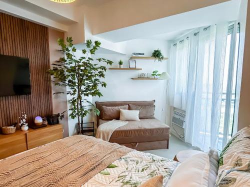 a bedroom with two beds and a tv in it at Sky26 Stays by Paula & Hudson in Pampang