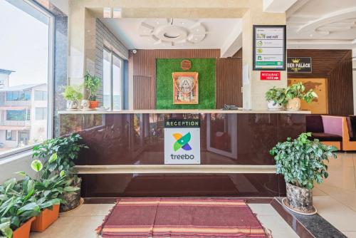 a reception area of a hospital with plants at Treebo Kuber Palace with Swimming Pool in Mahabaleshwar