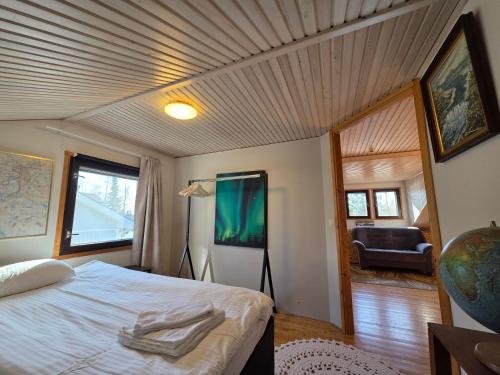 a bedroom with a bed and a couch in a room at Gold Digger's Timber in Inari