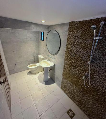 a bathroom with a toilet and a sink and a shower at Evergreen Private Pool Villa - Cavite in General Trias