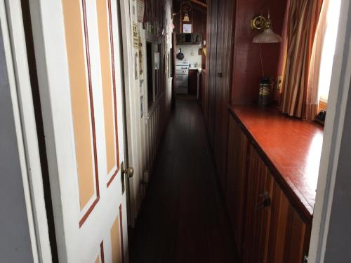 a hallway with an open door to a kitchen at Catalina Island Seacrest Inn in Avalon