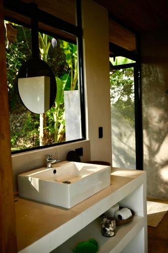 a bathroom with a sink in front of a window at Villa Wayra in Santa Teresa Beach