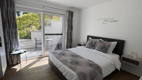 a bedroom with a bed and a sliding glass door at Ô Secret du Wérihay in Spa