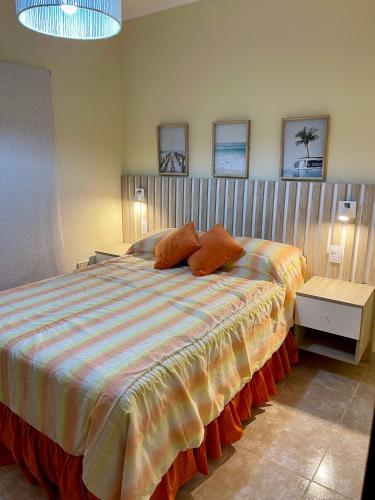 a bedroom with a large bed with two pillows on it at Chill Home VIII in Posadas