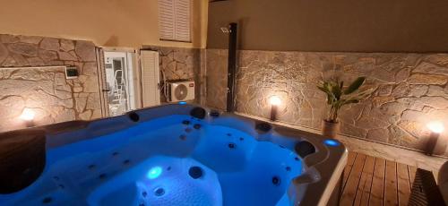 a large blue tub in a bathroom with two lights at Casa Sparto in Meganisi