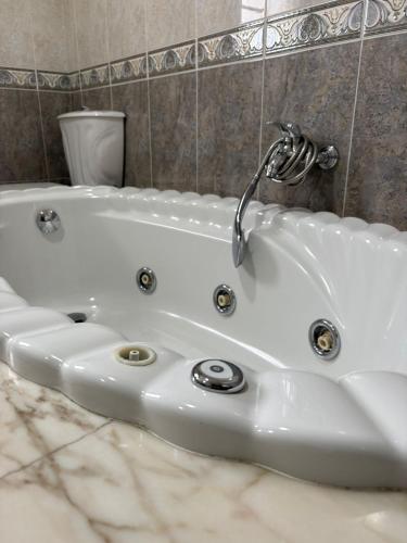 a white bath tub with a faucet in a bathroom at Casa Mar de Neaño in Neaño