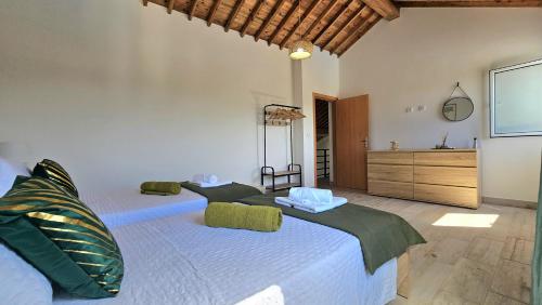 a bedroom with two beds and a dresser at Blue Lagoon Villa in Achada