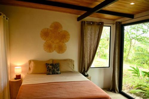 a bedroom with a bed and a large window at Villa Wayra in Santa Teresa Beach