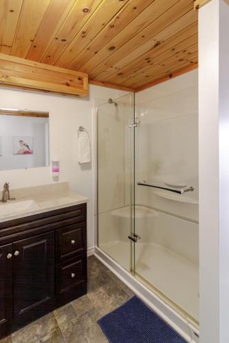 a bathroom with a glass shower and a sink at Westlake Consecon Cottage in Wellington