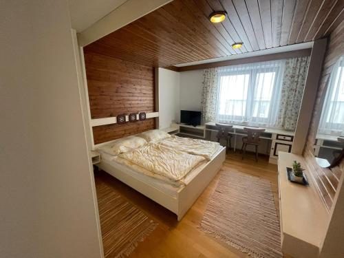 a bedroom with a bed and a dining room at Landhotel Max & Moritz in Liebenau
