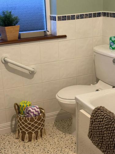 a bathroom with a toilet and a sink and a window at Ocean Heights House in Dunfanaghy