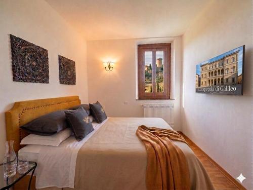 a bedroom with a large bed with black pillows at La Specola di Galileo con ampia vasca idromassaggio in Acquasparta