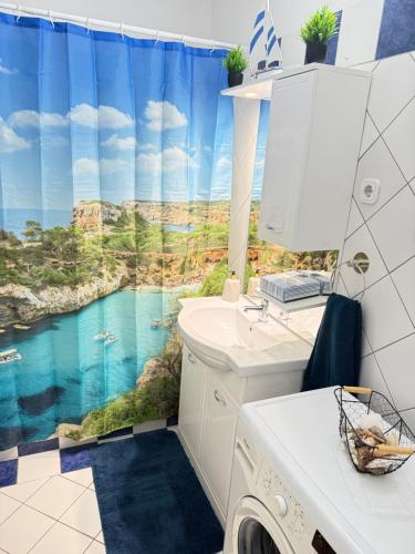 a bathroom with a view of a mountain shower curtain at Thermal Oazis Apartman in Mosonmagyaróvár