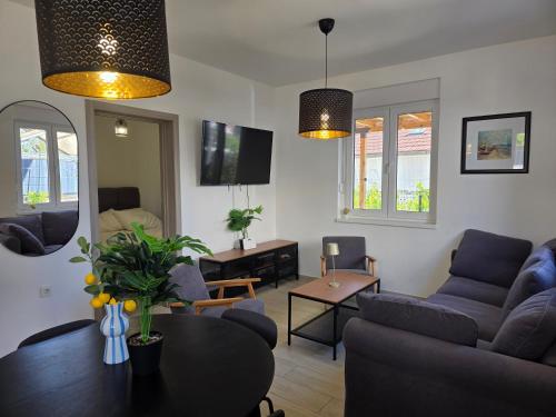 a living room with a couch and a table at Summer house Le Vito in Tribunj