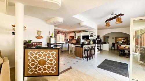 a kitchen and a living room with a counter top at Dar Kmaar in Hammamet