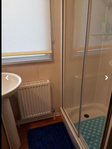 a bathroom with a shower and a sink at Jaynes Holiday Caravan Marton Mere in Blackpool