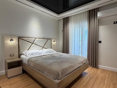 a bedroom with a large bed and a window at Blue Star Apartments in Ulcinj