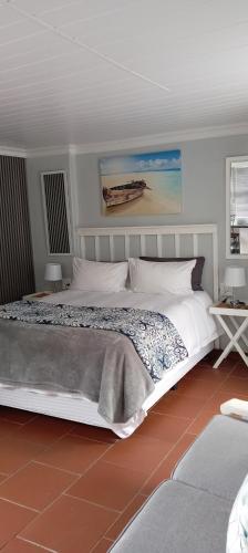 a bedroom with a large white bed in a room at 16 on Point in Parow