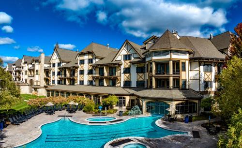a large apartment building with a swimming pool at Boyne Mountain Resort in Boyne Falls