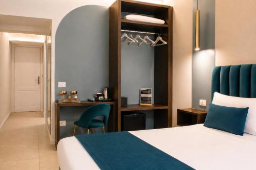 a hotel room with a bed and a chair at Museo Suite in Naples