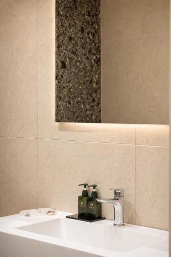 a bathroom with a sink and a mirror at Museo Suite in Naples