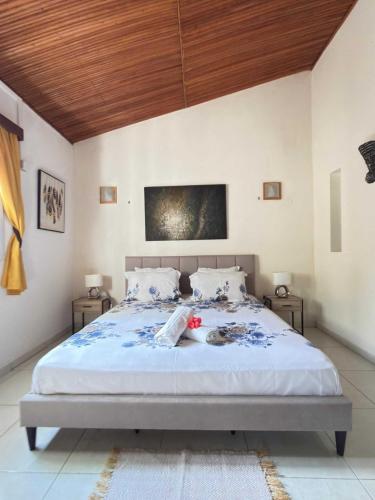 a bedroom with a large bed with a wooden ceiling at Villa Prisca in Sainte Marie