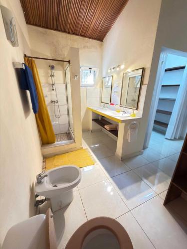 a bathroom with a toilet and a shower and a sink at Villa Prisca in Sainte Marie