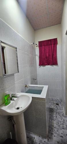 a bathroom with a sink and a bath tub at María House in San Miguel