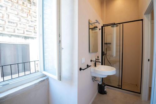 a bathroom with a sink and a shower and a window at Borgo Puglia in Bisceglie