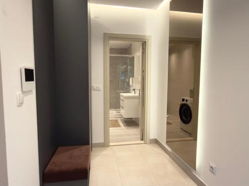 a bathroom with a mirror and a toilet in a room at Bright Apartment with Balcony near Bus and Train in Mostar