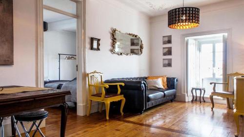 a living room with a couch and a table at Find Me Inn Boutique Penthouse in Lisbon