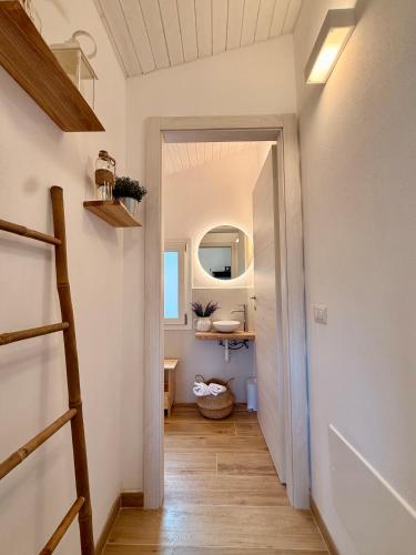 a hallway with a staircase leading to a bathroom at Casetta a Lago in Onno