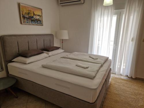 a bedroom with a bed with two pillows on it at Apartman Mona in Mostar