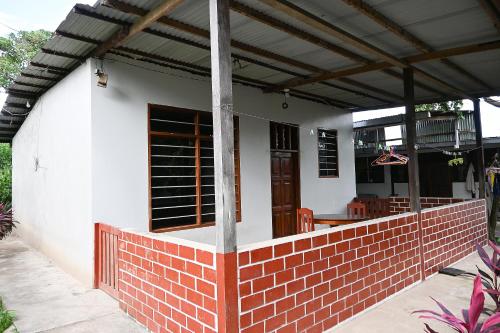 a house with a brick wall and a roof at Depa en Pto Maldonado in Puerto Maldonado