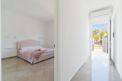 a bedroom with a bed and a glass door at Domus Afrodite - Torre Squillace in Torre Squillace