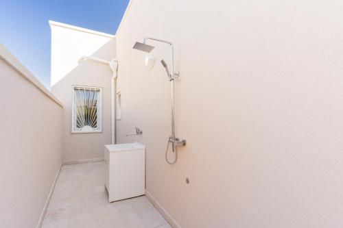 a white bathroom with a shower and a toilet at Domus Afrodite - Torre Squillace in Torre Squillace