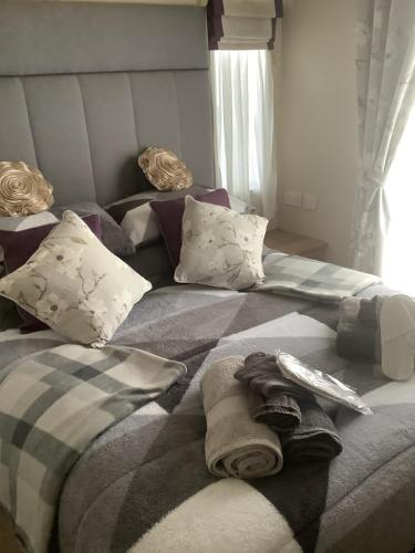 a bed with pillows and towels on top of it at Home from Home in Eyemouth