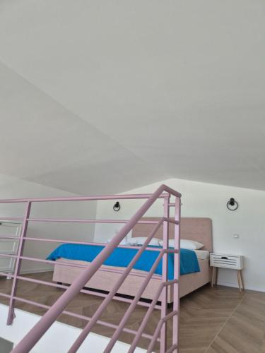 a bedroom with a bunk bed with a ladder at Gonik NN Apartmani in Veliko Gradište