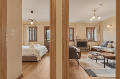 a bedroom with a bed and a living room at Metsovo Fireplace Retreat 2 in Metsovo