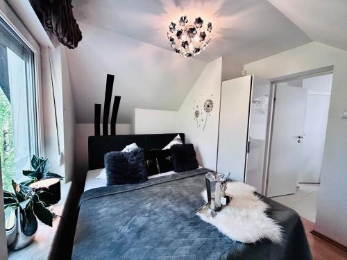 a bedroom with a large bed and a chandelier at Dora Design House in Człuchów
