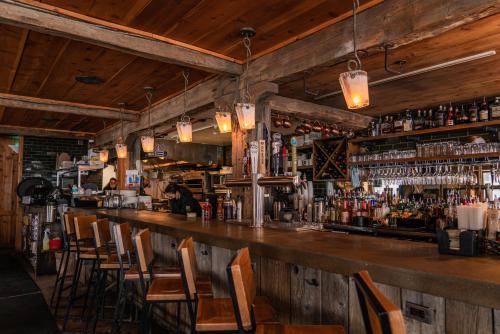 a bar with chairs and a counter with alcohol at Boyne Mountain Resort in Boyne Falls