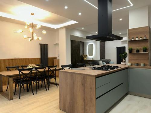 a kitchen and dining room with a table and a stove at CR home in Pompei in Pompei