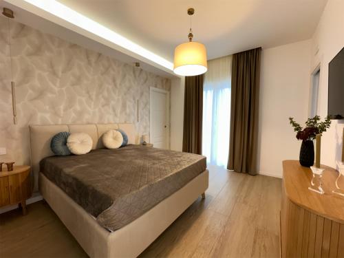 a bedroom with a large bed with pillows on it at CR home in Pompei in Pompei