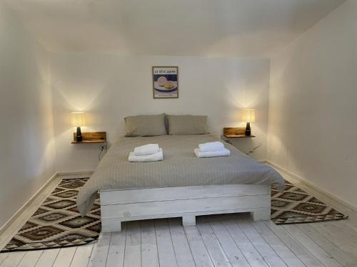 a bedroom with a bed with two towels on it at Casa Collina - Isola in Pisticci