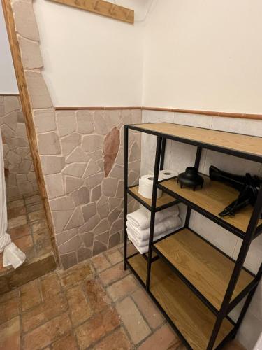 a shelf in a room with a wall at Casa Collina - Isola in Pisticci