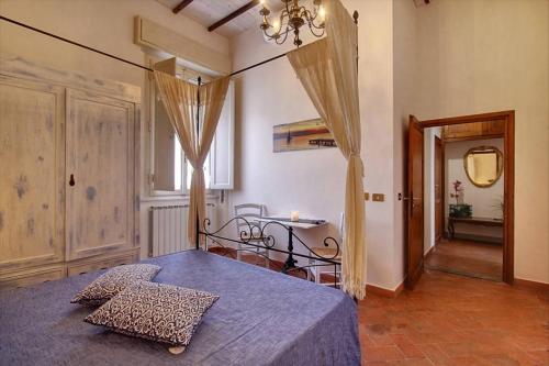 a bedroom with a bed and a table and a window at Bronzino Apartment in Florence