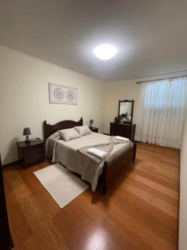 a bedroom with a bed and a mirror in it at Rdj B in Porto Moniz