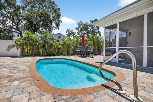 a swimming pool in the backyard of a house at Buffalo Bungalow in Clearwater Beach